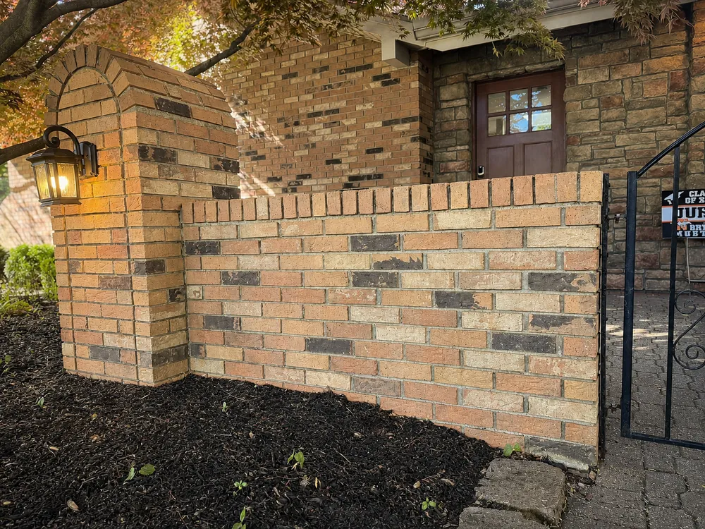 The same Northville brick wall after soft washing, clean and restored